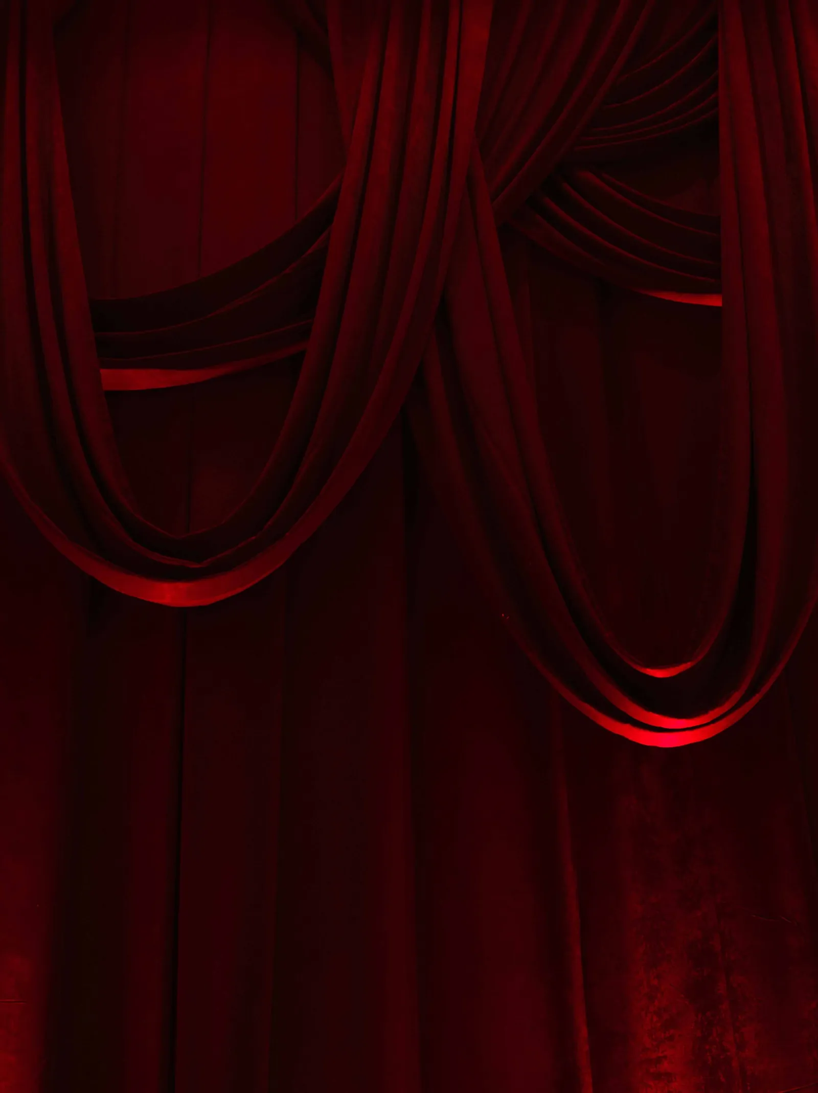 Deep crimson velvet drapes in looping swags